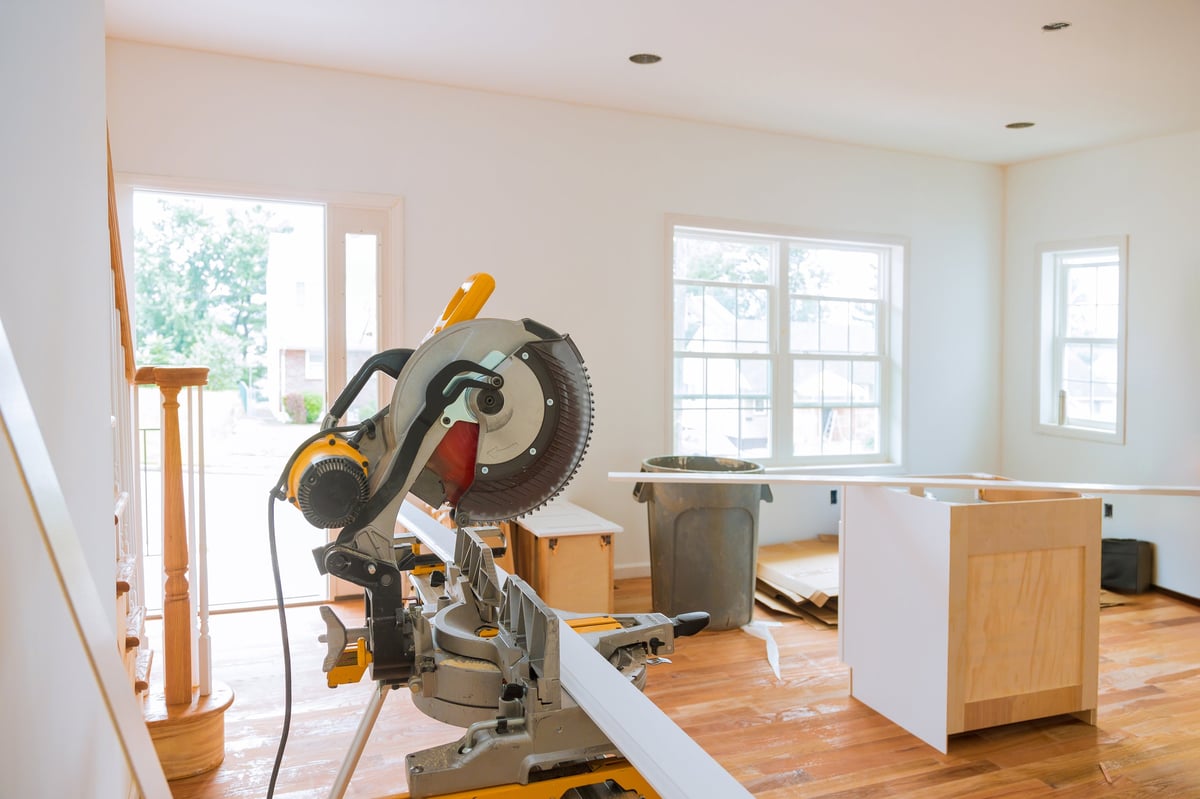 A circular saw and trim molding materials during a finish carpentry installation